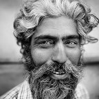 28mm portrait of a smiling man with beard