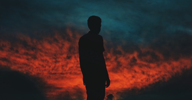 50916-man-standing-sunset-dark1200u.1200w.tn