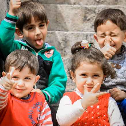 girl and three boys on staircase